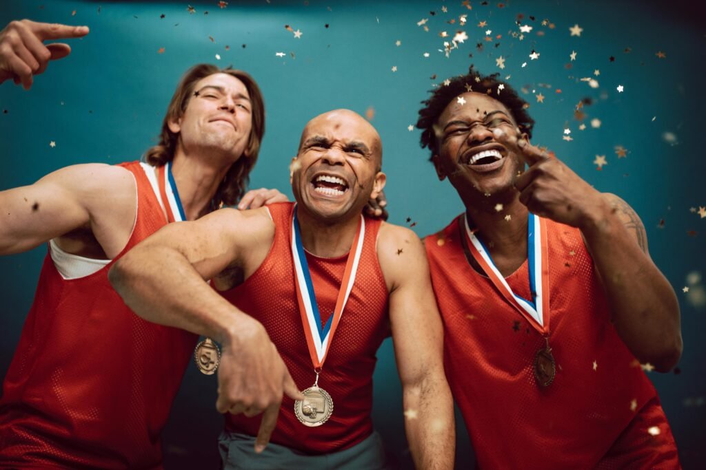 pexels-photo-7005759-7005759 Three diverse athletes celebrate their victory with medals and confetti.